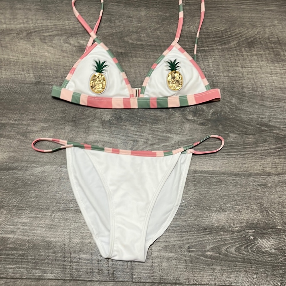 White, pink, green colored bikini. pineapples on each side of the top.